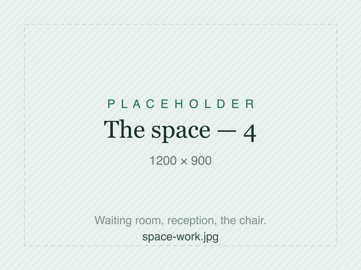 A long communal table, laptops and mugs down both sides